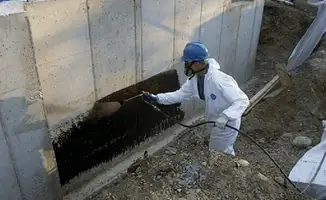 Professional waterproofing the exterior walls of the basement in Tampa, FL